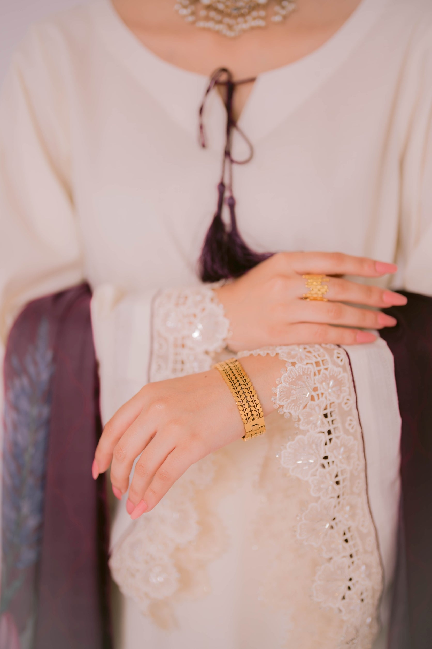 Pair of golden whisper cuff and golden abstract ring